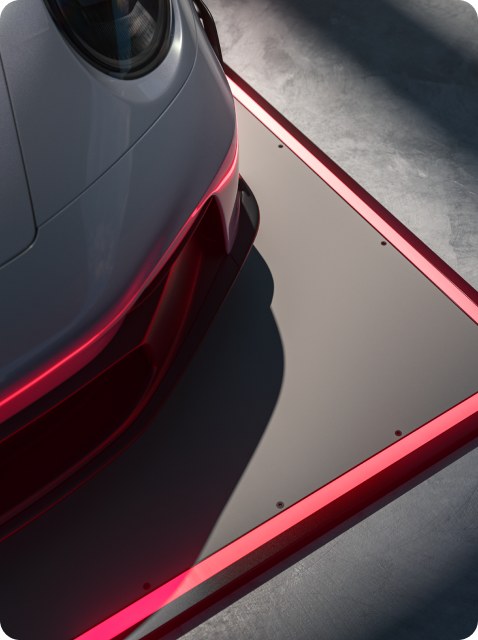 Auto auf einem grauen Pad mit roter LED-Beleuchtung an den Rändern, grauer Boden im Hintergrund.
